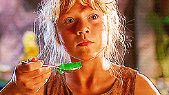 Scene from the movie Jurassic Park in which the young female character Ellie looks scared because her spoonful of Jello is shaking due to the approach of dinosaurs. 
