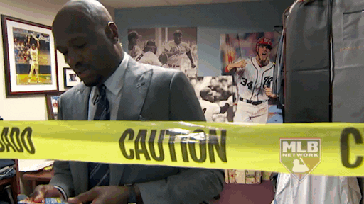 Animated gif of a main in a suit pushing through yellow "Caution" tape, symbolizing the potential red flags in the therapist's Google Ads account 