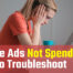 Woman looking at a laptop in frustration, wondering "Why are my Google Ads not spending?"